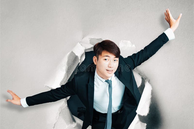 Asian businessman Breakthrough paper hole stock image Asian businessman Breakthrough paper hole stock image