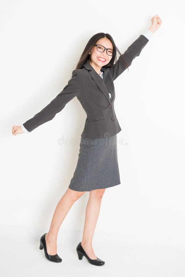 full body picture of a happy young business woman standing Stock