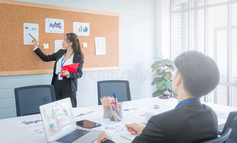 Businesswoman is presenting report and plan on wooden board for manager with confidence stock images
