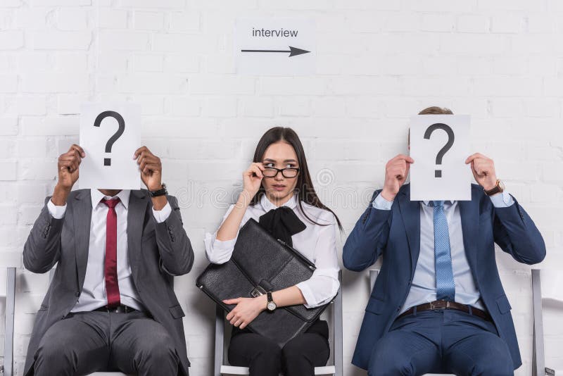asian businesswoman sitting near multicultural businessmen that holding cards with question marks while waiting royalty free stock photos asian businesswoman sitting near multicultural businessmen that holding cards with question marks while waiting royalty free stock photos