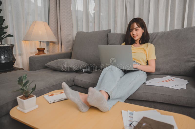 Asian businesswoman working online alone at home. Woman lifestyle in living room. Social distancing