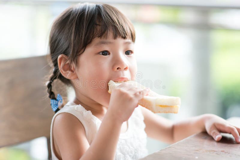 Asian Child eating bread