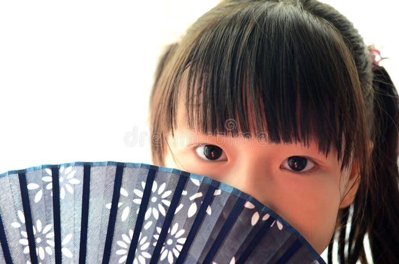 Asian child Holding the Paper fan