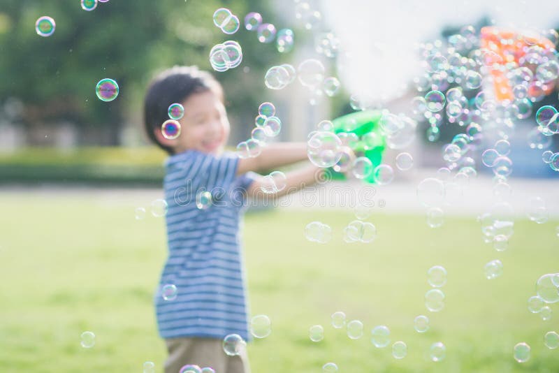 Asian Child Shooting Bubbles from Bubble Gun Stock Image Image of