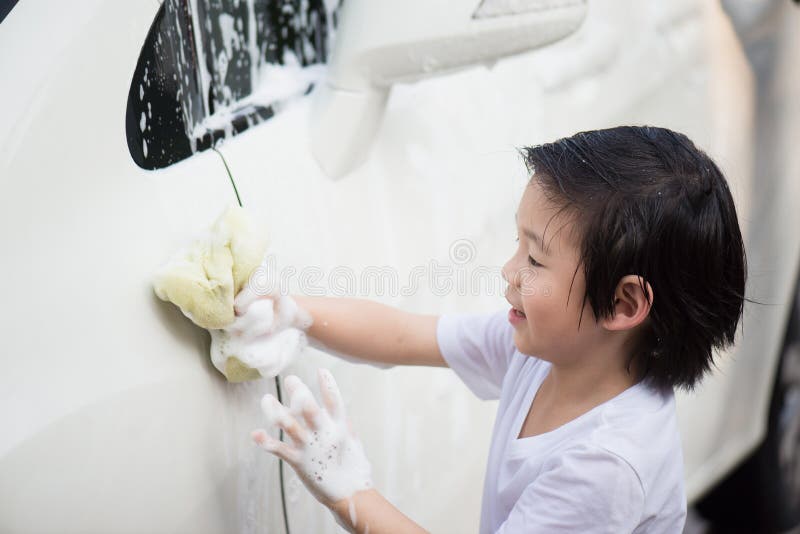 Asian children washing car