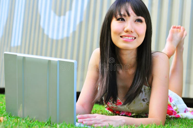 Asian Chinese Girl using laptop and thinking