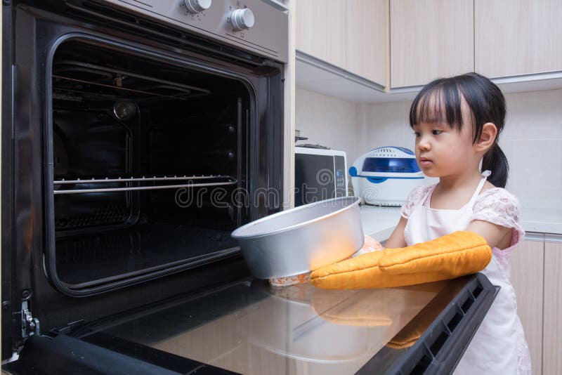 Asian Chinese little girl baking cake. Domestic, cooking.
