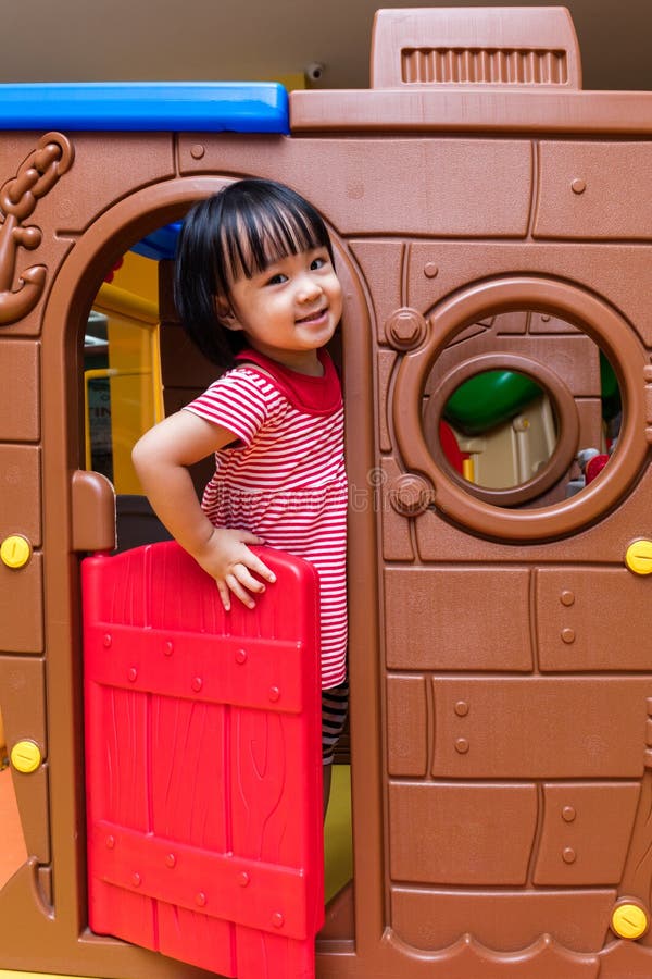 Asian Chinese little girl playing in toy house