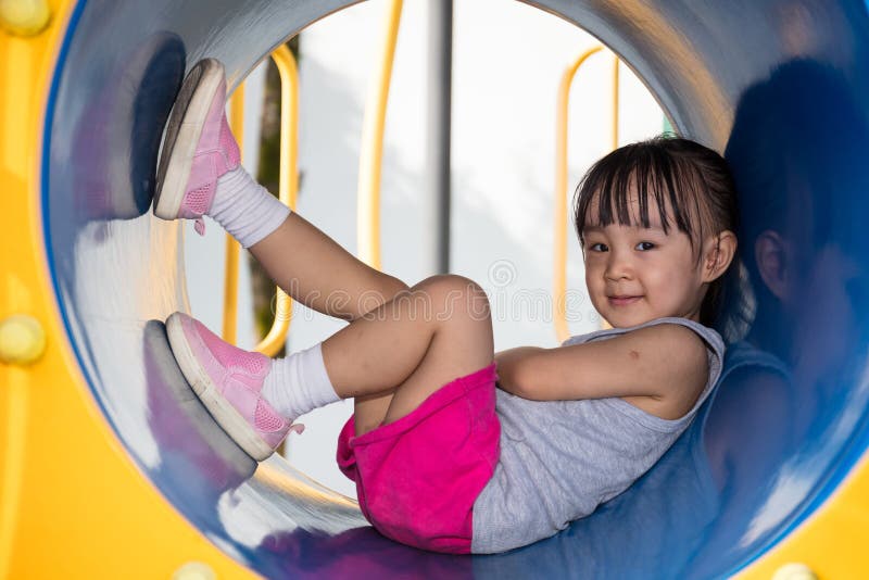 Asian Chinese little girl sitting in the tunnel