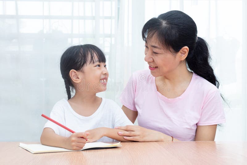 Asian Chinese Mother Teaching Daughter Doing Homework Stock Image