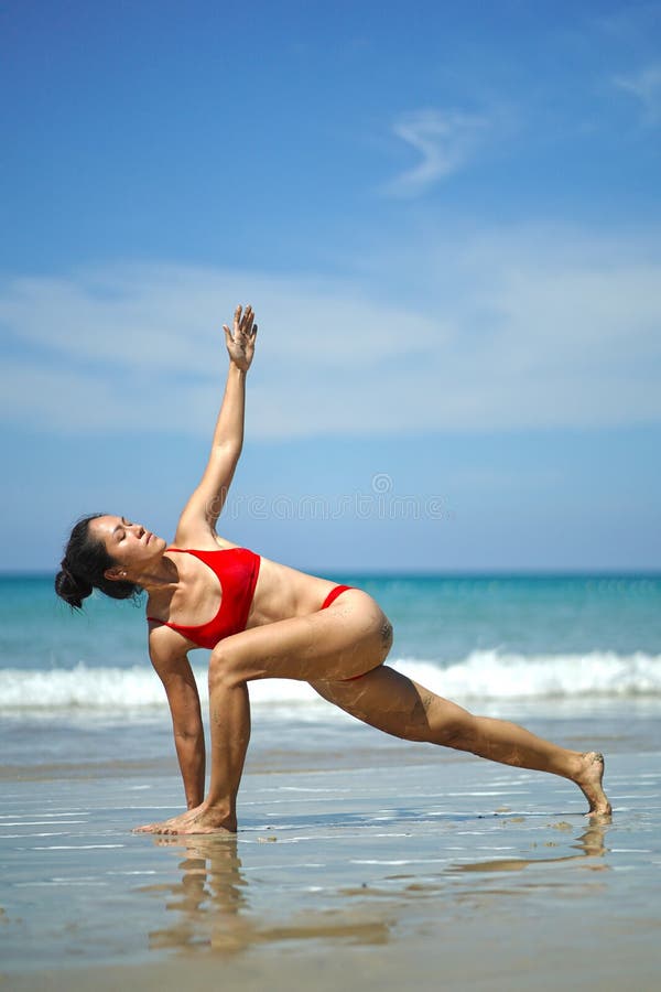 Woman performing yoga on the beach stock image Stock Photo by ©felixtm  49722001
