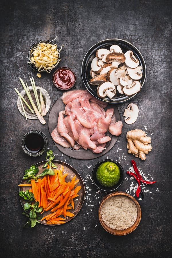 Asian Cooking Ingredients For Chicken Rice Dish With Vegetables On Dark