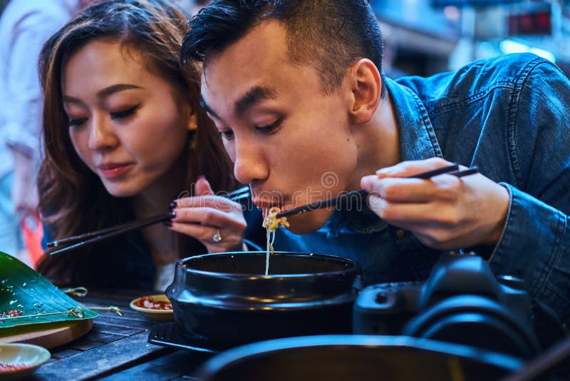 Asian couple are eating at chinese cafe