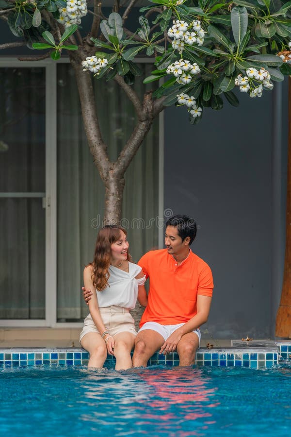 Asian Couple Have Goodtime Together On Summer Vacation At Pool Side In Hotel And Resort Stock
