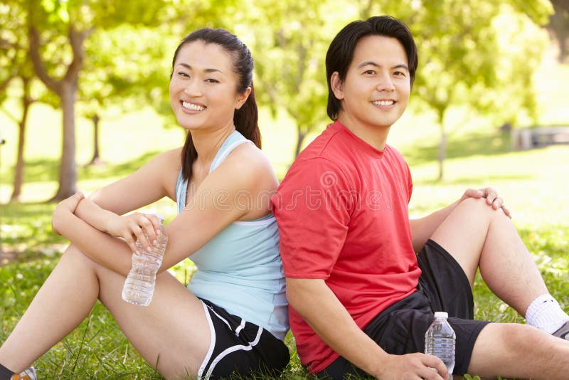Asian couple resting after exercise stock photos