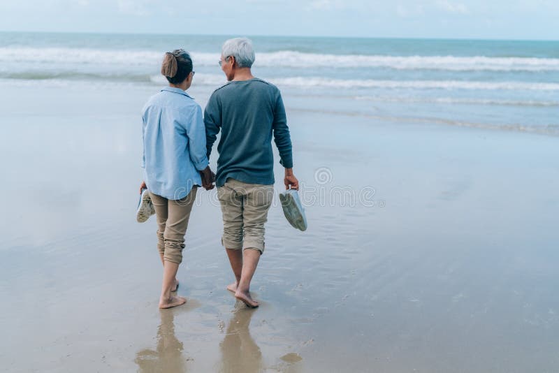 Asian couple senior elder retire resting relax walking running at sunset beach