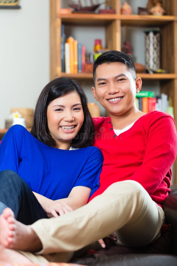 https://thumbs.dreamstime.com/b/asian-couple-sofa-young-indonesian-men-women-sitting-home-couch-s-weekend-enjoying-leisure-time-35450957.jpg