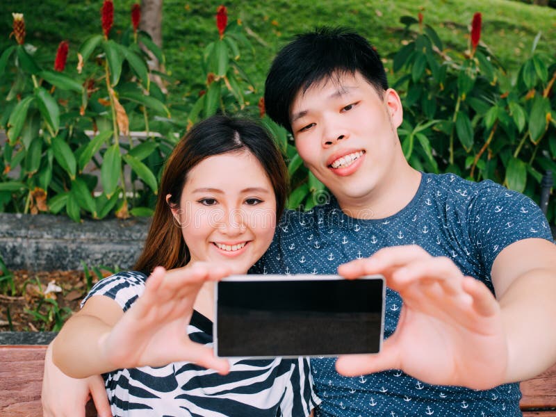 Watching outdoor couple asian