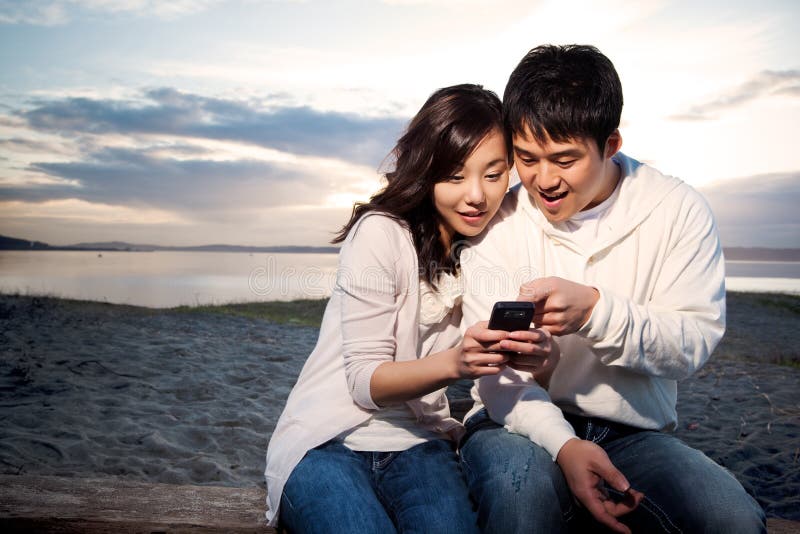 Asian couple texting stock photos.