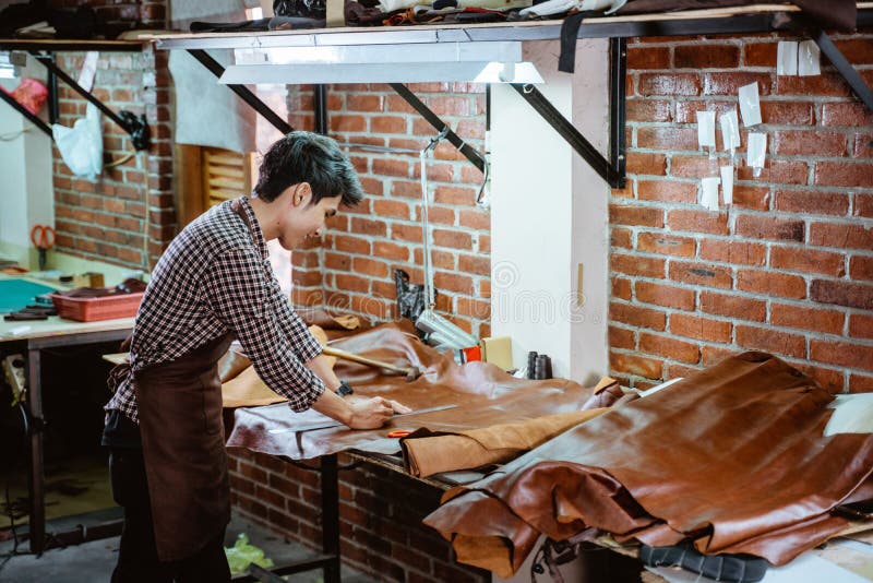 Asian Craftsman in Apron Working with Leather Making Leather Crafts