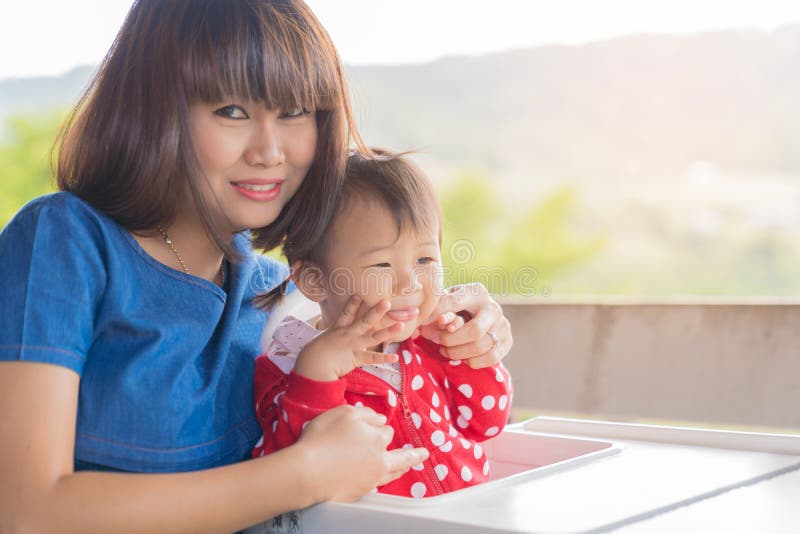 Asian cute baby girl and beautiful mother enjoyful on mountain b