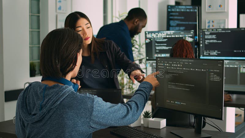 Asian Database Developers Analyzing Compiling Code on Multiple Screens ...