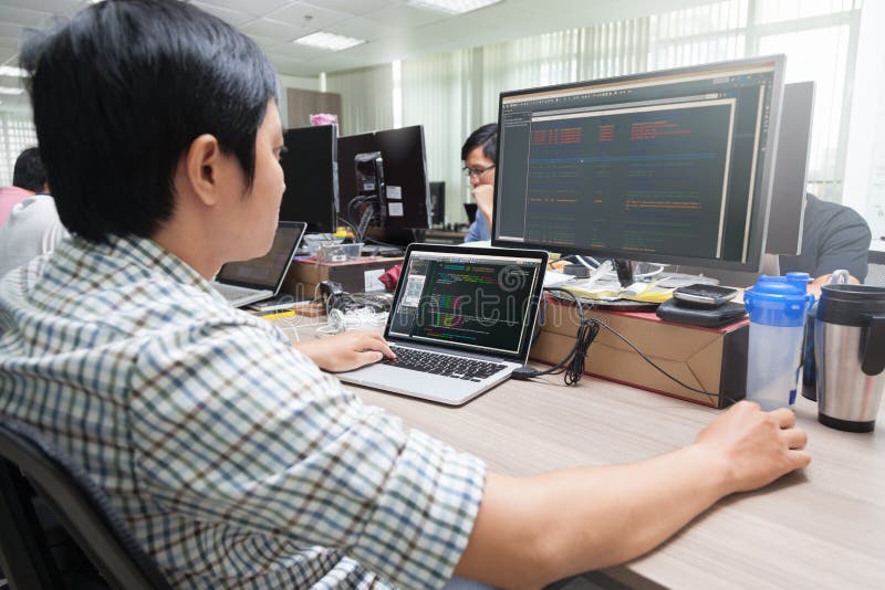 Asian Developer Using Laptop Computer Sitting stock photography Asian Developer Using Laptop Computer Sitting stock photography