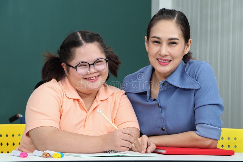 Asian disabled children Or, an autistic child learns to read, write and train their hand and finger muscles with a teacher at