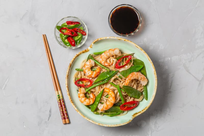 Asian dish of fried rice noodles with shrimp and vegetables. The view from the top. Copy-space. royalty free stock images Asian dish of fried rice noodles with shrimp and vegetables. The view from the top. Copy-space. royalty free stock images