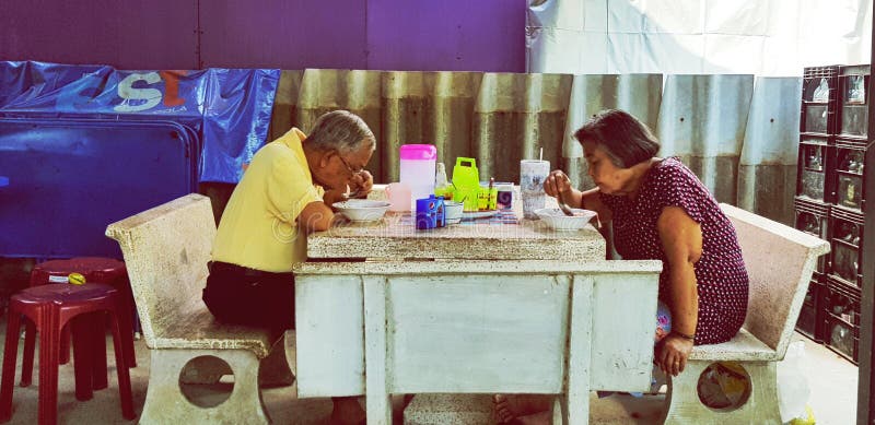 Asian Elder people or Husband and wife eating noodle at Thai local street food royalty free stock image Asian Elder people or Husband and wife eating noodle at Thai local street food royalty free stock image
