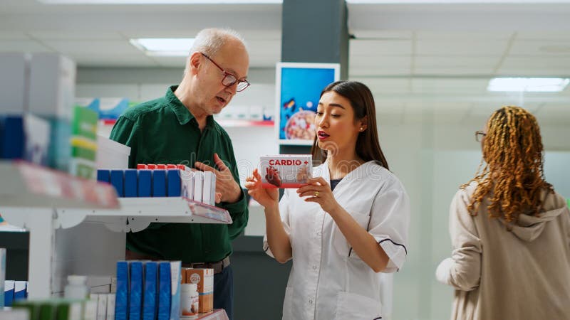Asian Employee Showing Drugs Boxes To Senior Client Stock Image - Image ...