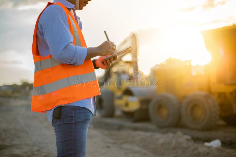 Asian engineer with hardhat using tablet pc computer inspecting and working at construction site royalty free stock image Asian engineer with hardhat using tablet pc computer inspecting and working at construction site royalty free stock image