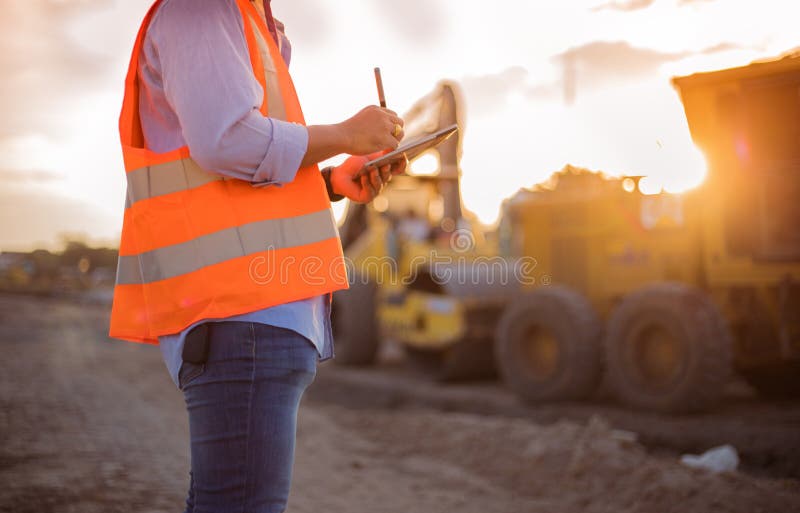 Asian engineer with hardhat using tablet pc computer inspecting stock images