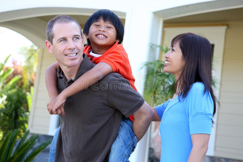 Attractive asian family outside their home having fun. Attractive asian family outside their home having fun