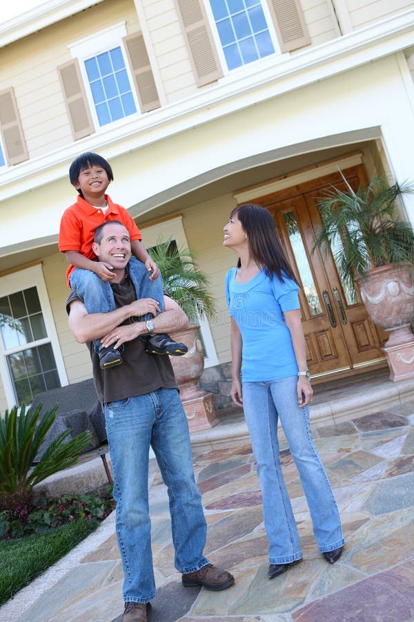 Attractive asian family outside their home having fun. Attractive asian family outside their home having fun