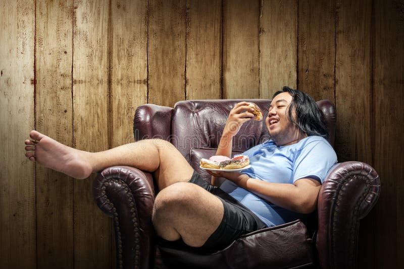 Asian fat man eating donuts on plate. 