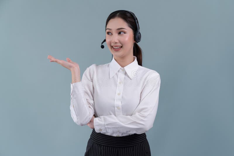 Asian operator wearing formal suit and headset with hand gesture. Enthusiastic stock photos