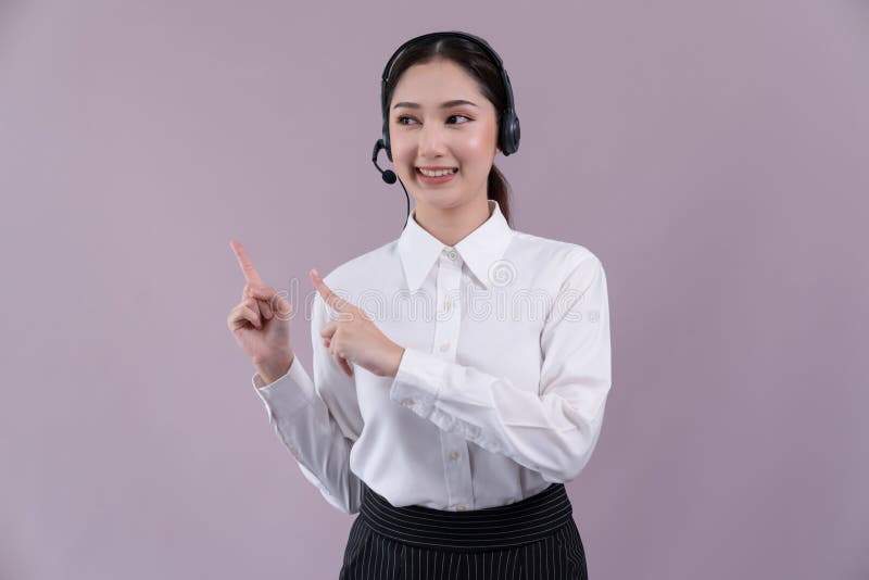 Asian operator wearing formal suit and headset with pointing finger Enthusiastic royalty free stock images