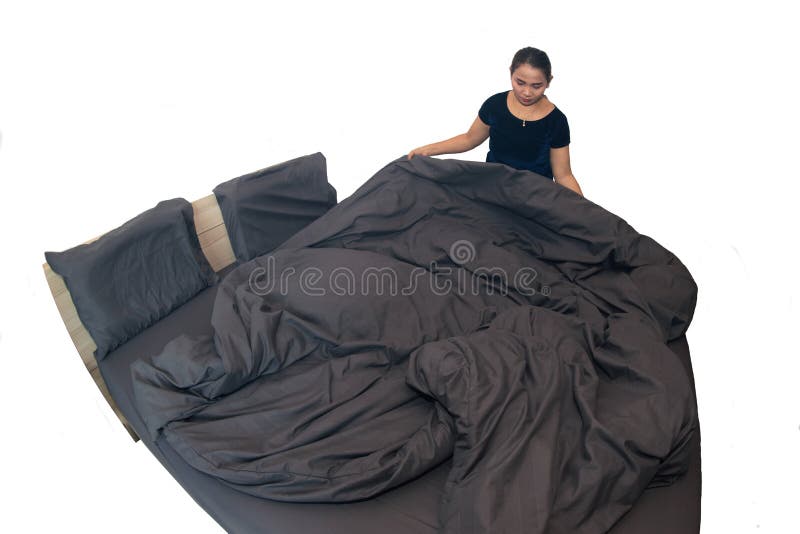 Asian female maid making bed in hotel room. Housekeeper Making Bed on white background with clipping path.