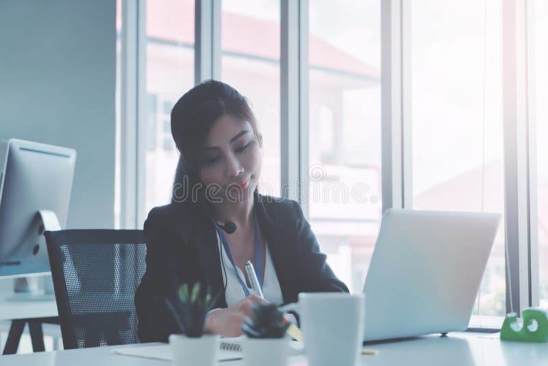 Female Operator is answering the phone for customer service sale and business consultant stock photography