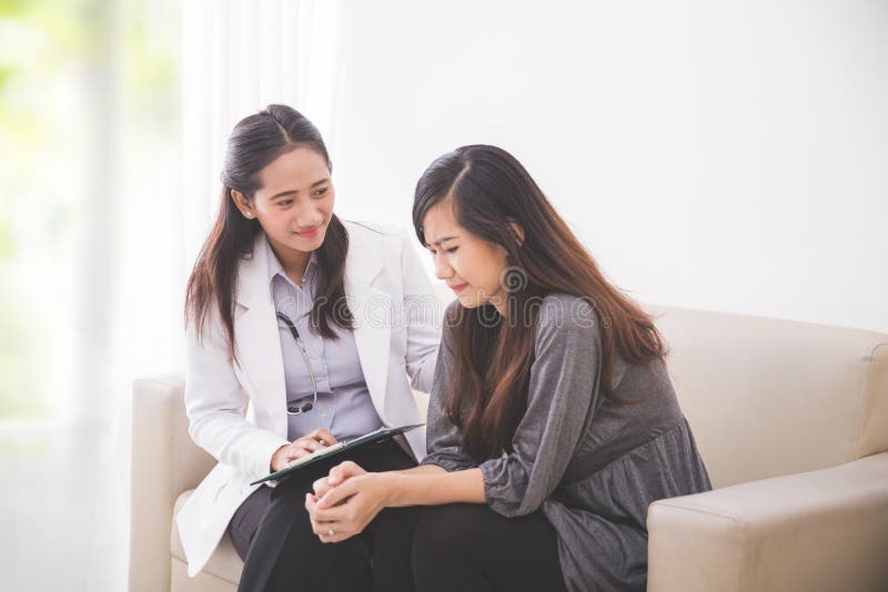 Asian female patient crying while consulting her health problem royalty free stock photo