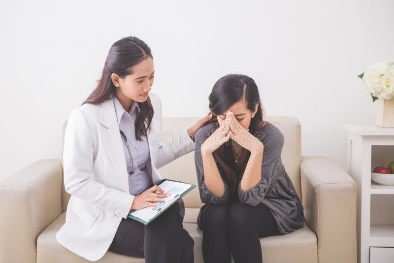 Asian female patient crying while consulting her health problem stock images