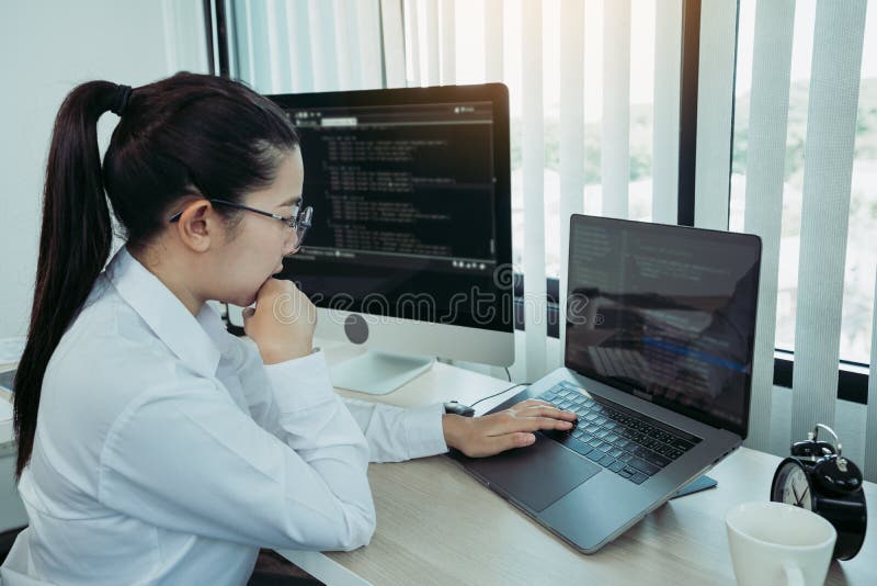 Asian female software developer is worried about analyzing code-based systems at his office royalty free stock photos