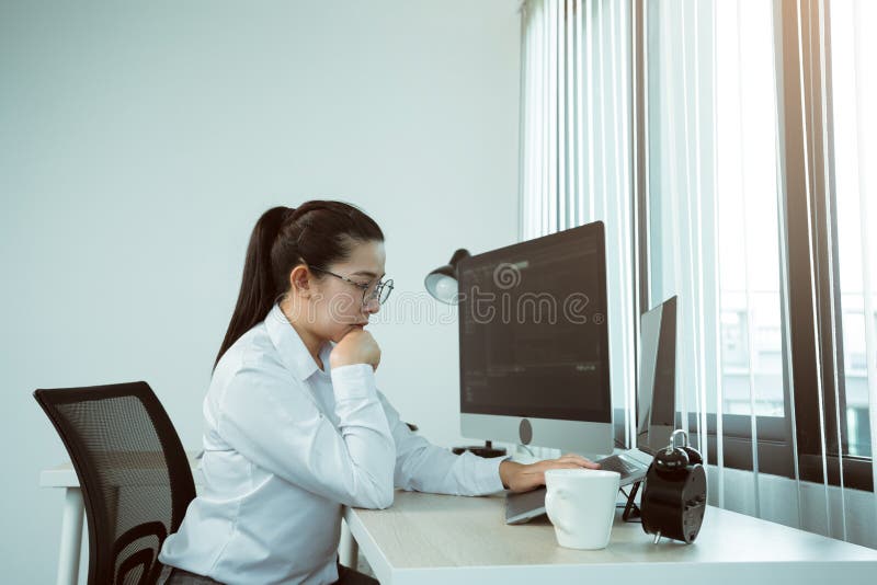Asian female software developers are stressed in analyzing code-based systems stock photo