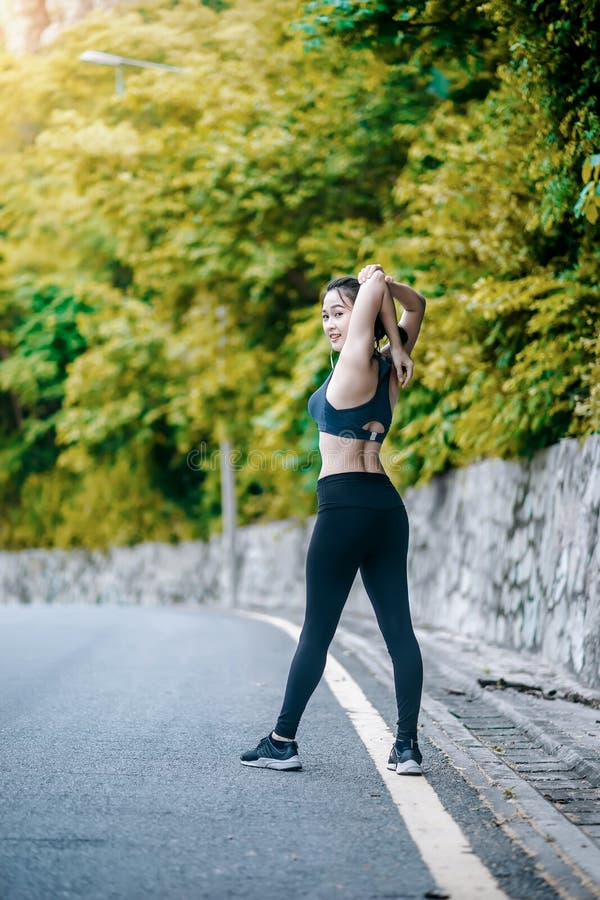 Asian Fitness Woman Runner Stretching Legs Before Run Stock Image 