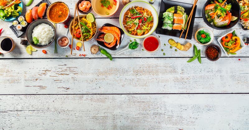 Asian food served on wooden table, top view, space for text