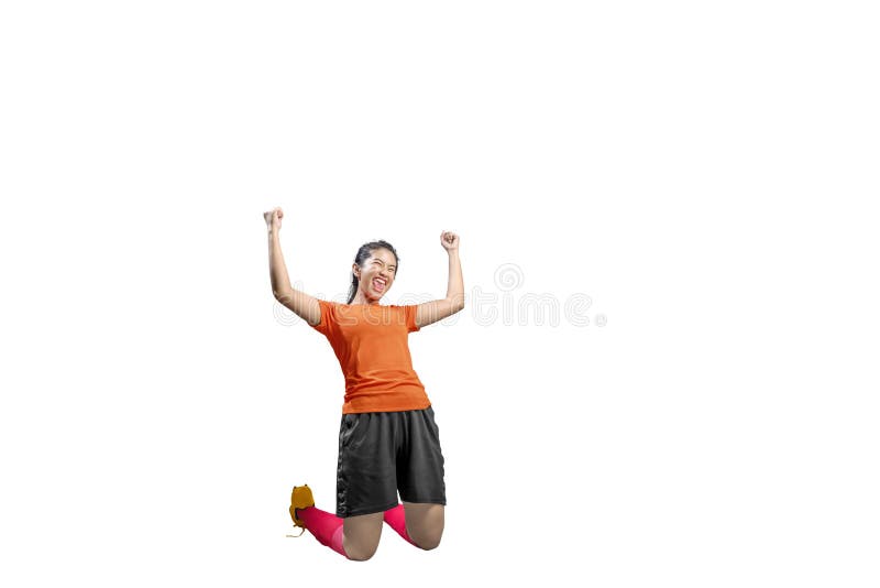 Asian football player woman celebrate her goal with raised arms and kneeling stock photos Asian football player woman celebrate her goal with raised arms and kneeling stock photos