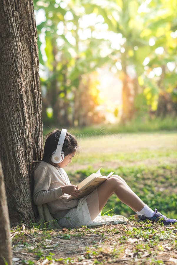 Asian girl with book and headphone siting