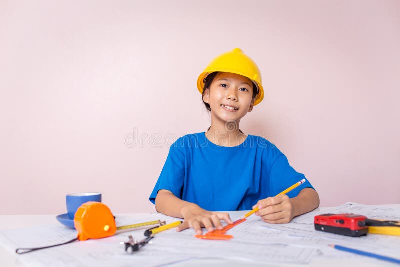 Asian girl child playing as an engineer the building layout