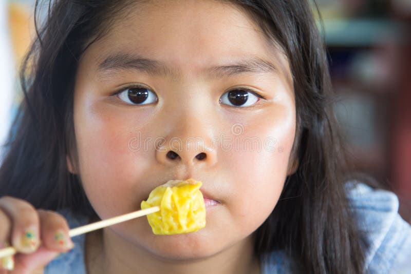Asian girl eating dumplings royalty free stock photos Asian girl eating dumplings royalty free stock photos